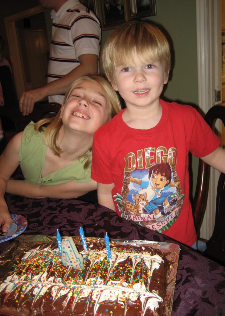 Picture of me and younger brother eating our first gluten free cake.