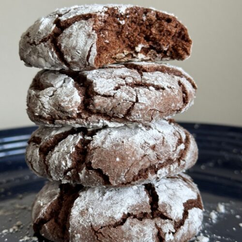 This pictures is a stack of Chocolate Crinkle Cookies.