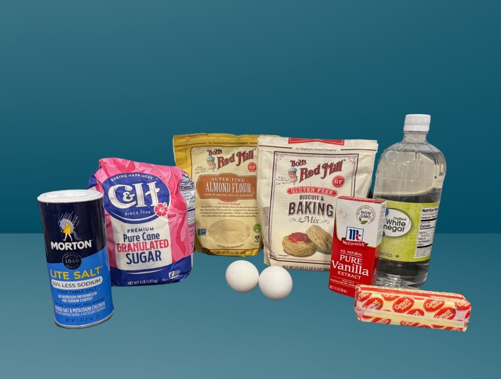 This is an image of ingredients used for the Strawberry Almond Muffins. This includes, salt, sugar, almond flour, gluten free baking flour, 2 eggs, stick of butter, vanilla extract and white vinegar.